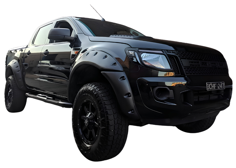 Black lifted pickup truck with off-road tires and custom fender flares, angled on a white background