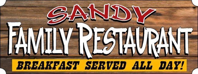 A sign for sandy family restaurant says breakfast served all day