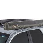 A car with a roof rack and a tent on top of it.