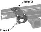 A black and white image of a piece of metal attached to a trailer.