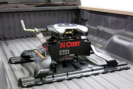 A curt hitch is attached to the back of a truck.