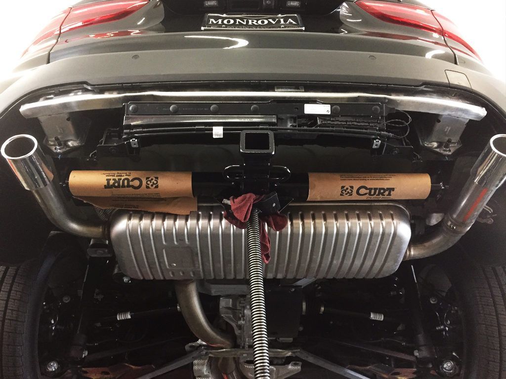 The exhaust pipes of a car with a license plate that says n curt