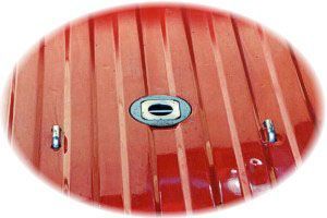 A close up of a red roof with a hole in it
