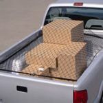 A silver truck with boxes in the back of it.