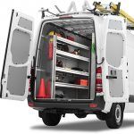 A white van with shelves and a ladder on top of it.