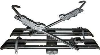 A black bike rack with two bikes attached to it on a white background.