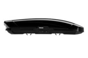 A black roof box is sitting on top of a white surface.
