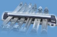 A bunch of skis are sitting on top of a roof rack.