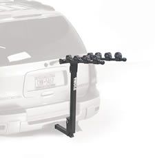 A bike rack is attached to the back of a car.