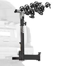 A thule bike rack is attached to the back of a car.