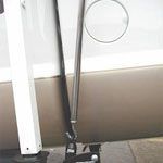 A vacuum cleaner is sitting on the floor next to a treadmill.