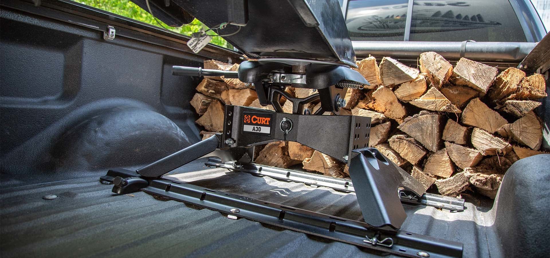 A truck bed with a bunch of wood in it.