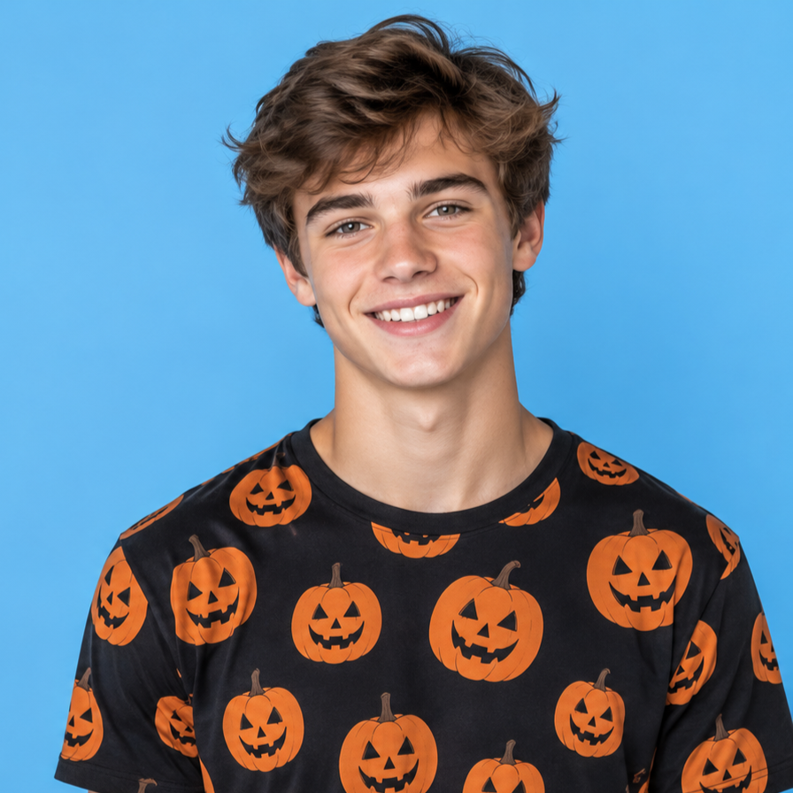 Smiling person in a black shirt with orange jack-o'-lanterns against a blue background