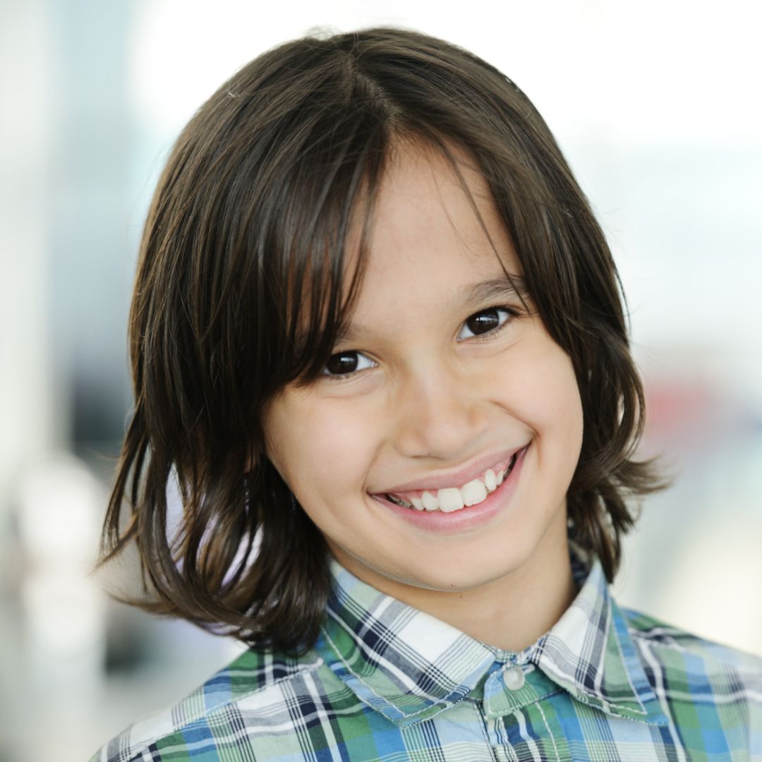 teenage girl with her eye closed, smiling