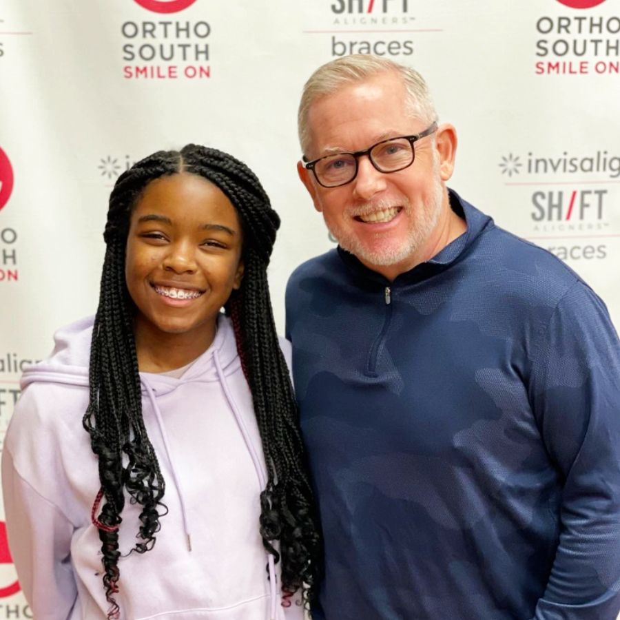 Dr. Boggan with a patient, teenage girl with braces