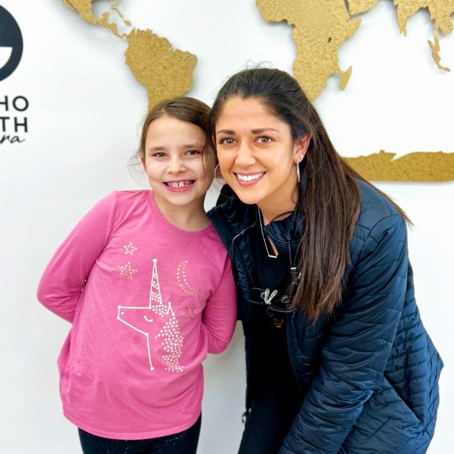 Dr. Syed with a patient, young girl with braces