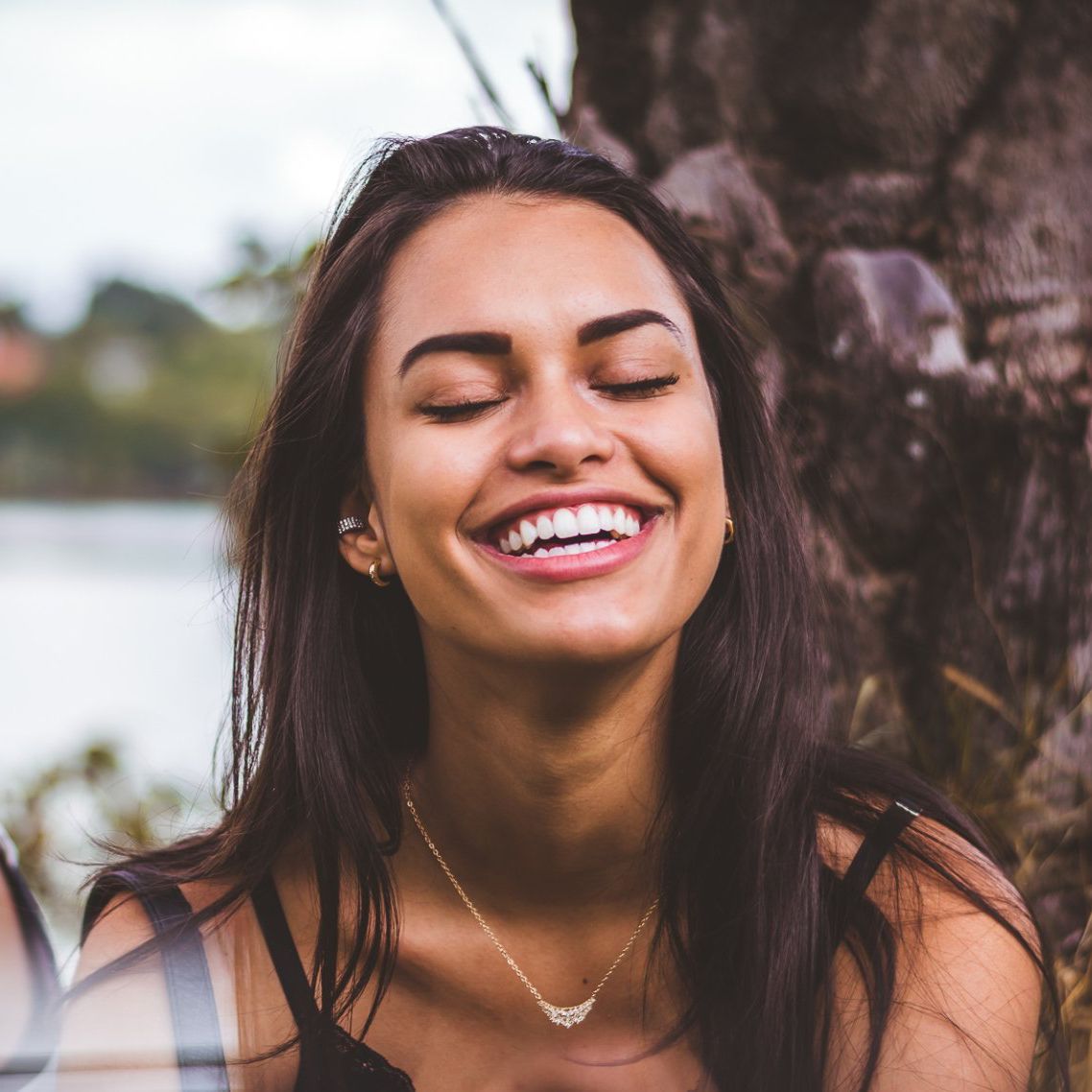 teenage girl with her eye closed, smiling