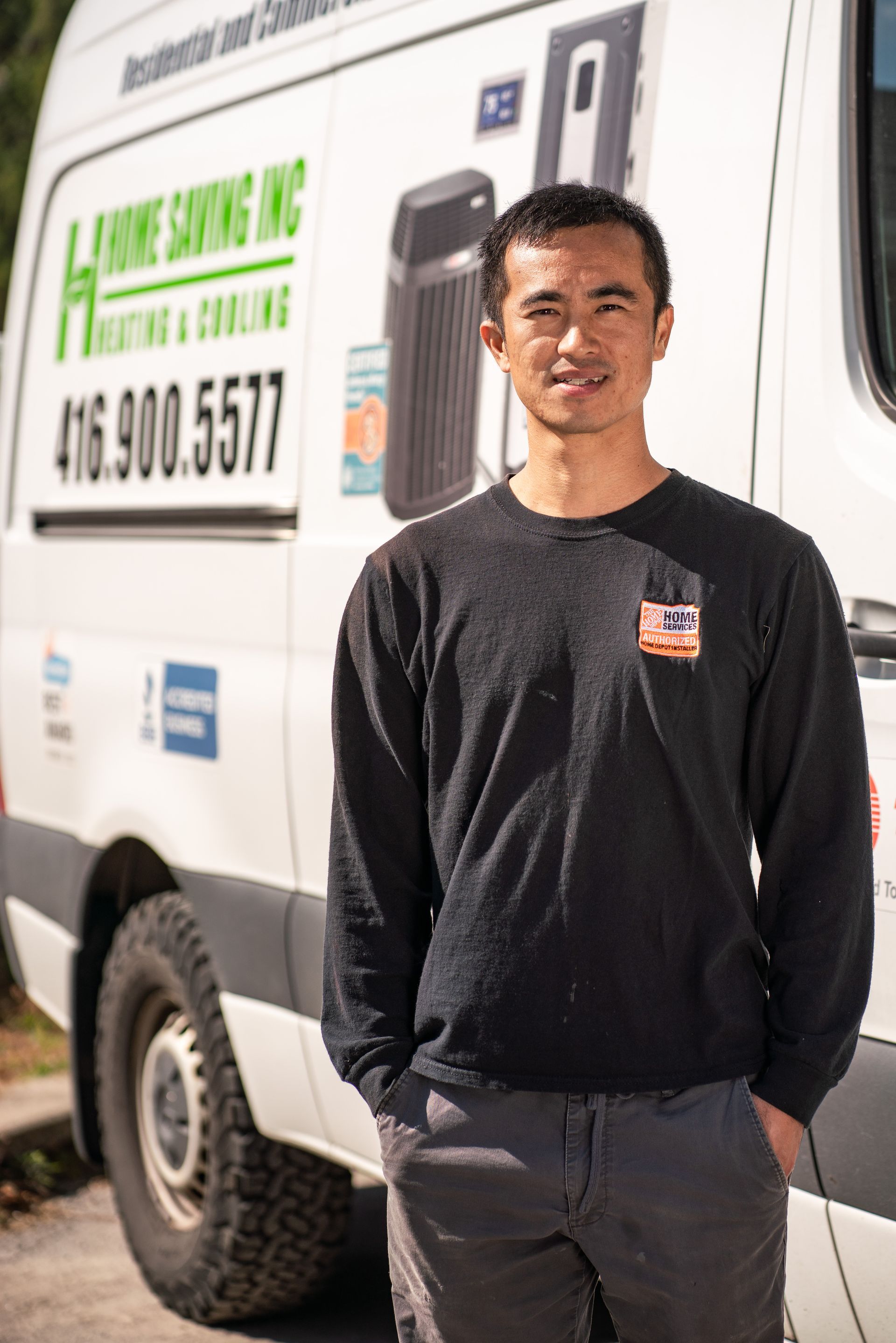 Man standing beside a white service van with company signage on the side