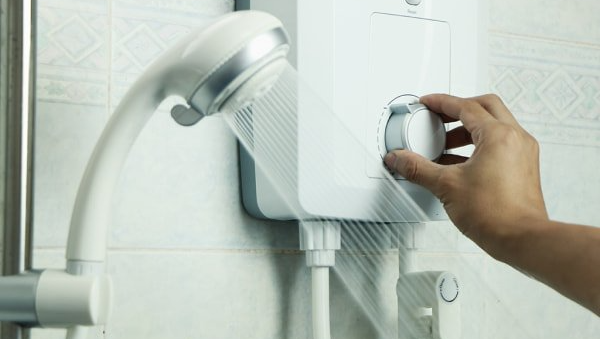 person adjusting water heater machine