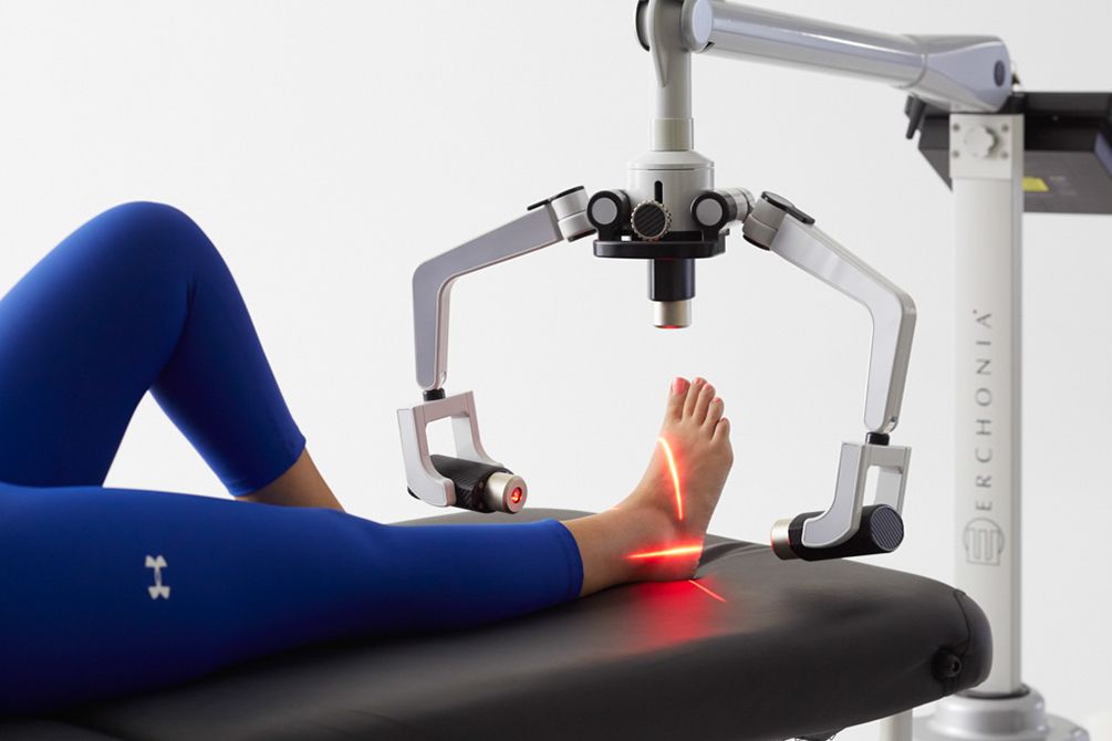 A person is laying on a table receiving low level light therapy