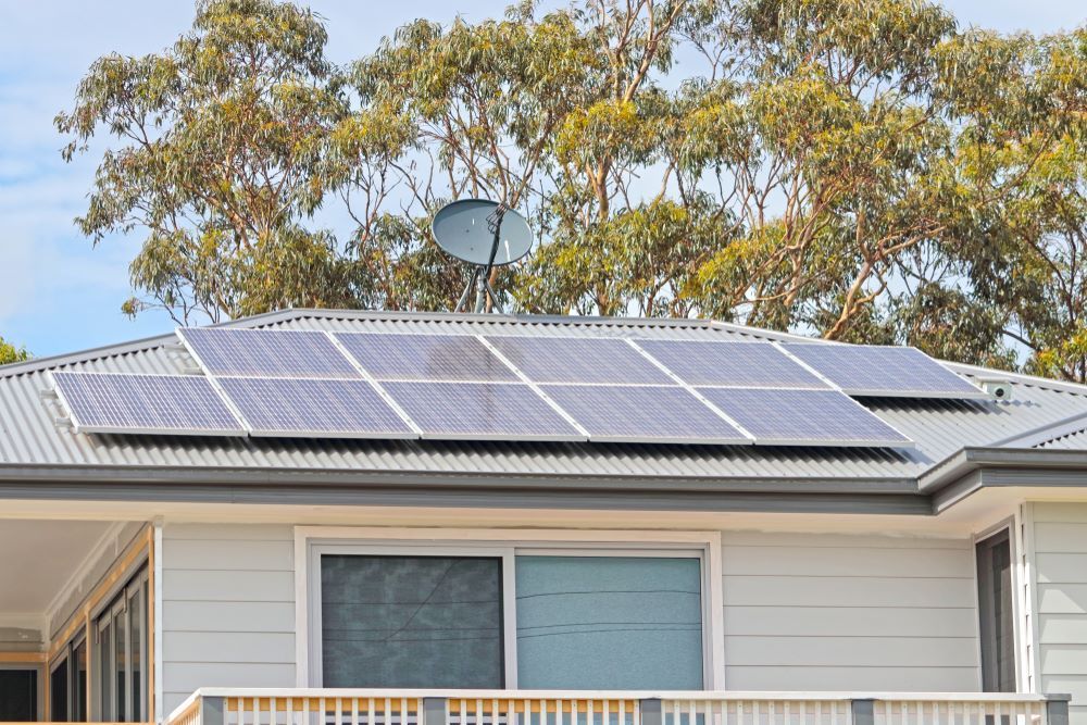 A House With a Clean Solar Panels and a Satellite Dish on the Roof — DJ's Pressure Cleaning In Tully, QLD