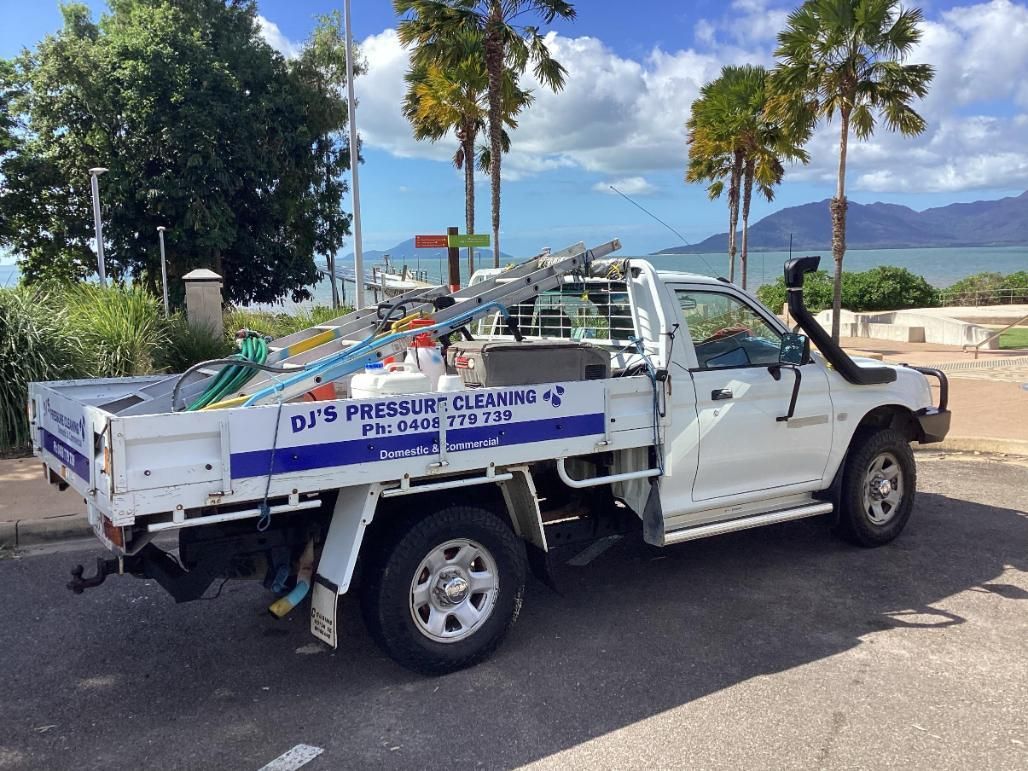 A White Truck is Parked on the Side of the Road — DJ's Pressure Cleaning In Carruchan, QLD