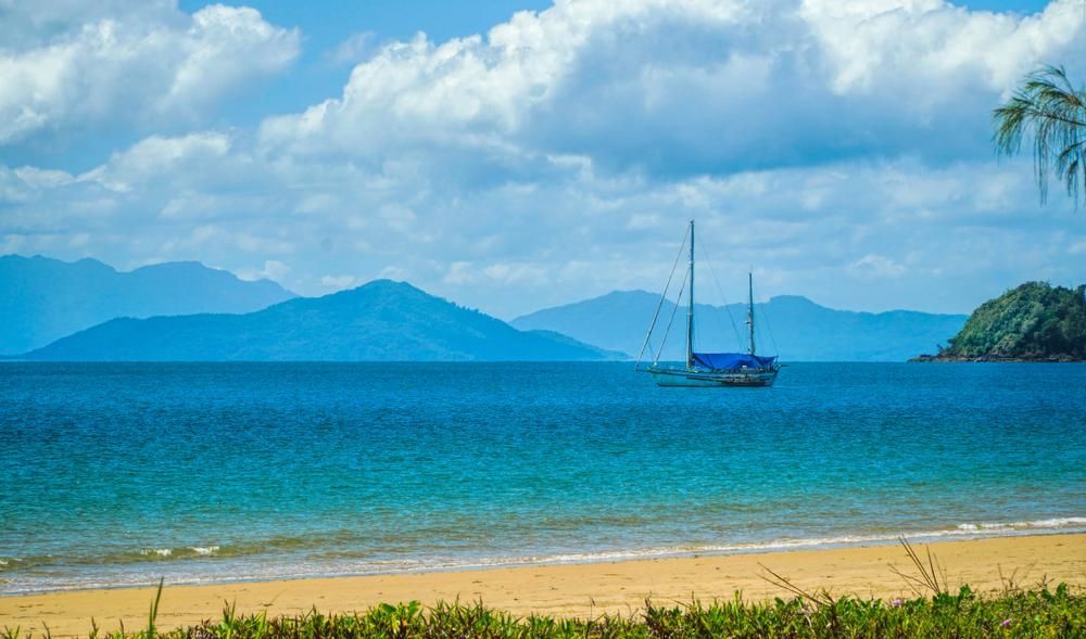 A Sailboat is Floating on Top of a Large Body of Water — DJ's Pressure Cleaning In Mission Beach, QLD