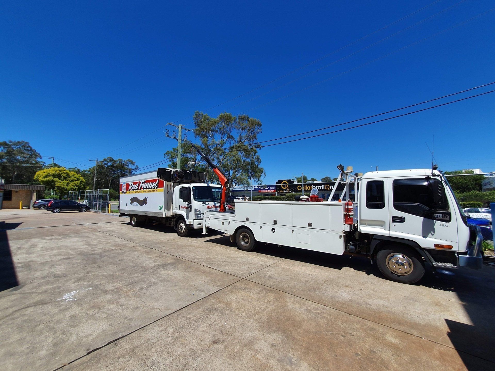A Man Is Working On A Truck In A Garage  — Newcastle Truck Repairs in Thornton, NSW