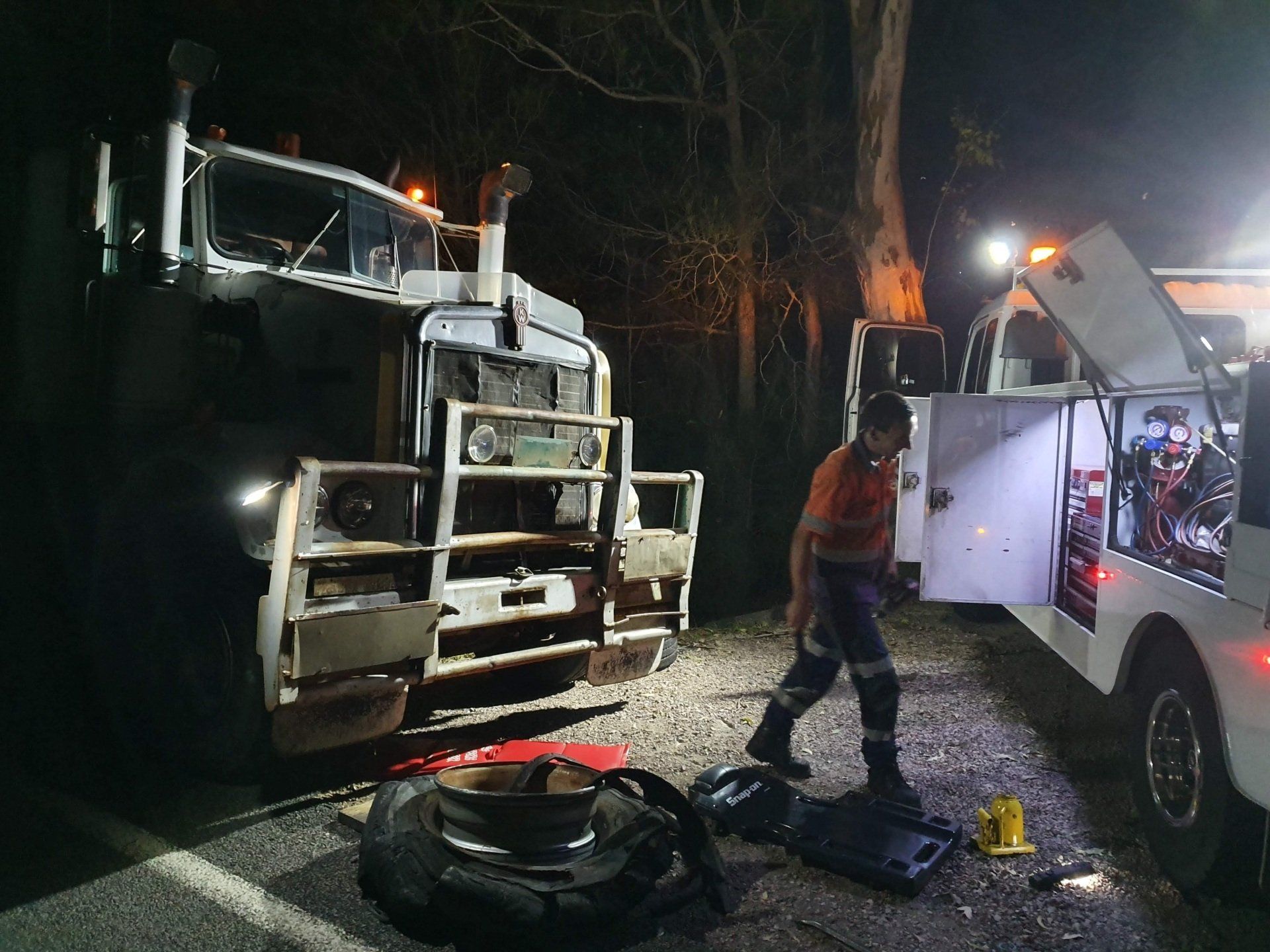 A Semi Truck Is Driving Down A Highway With A Trailer Attached To It — Newcastle Truck Repairs in Maitland, NSW