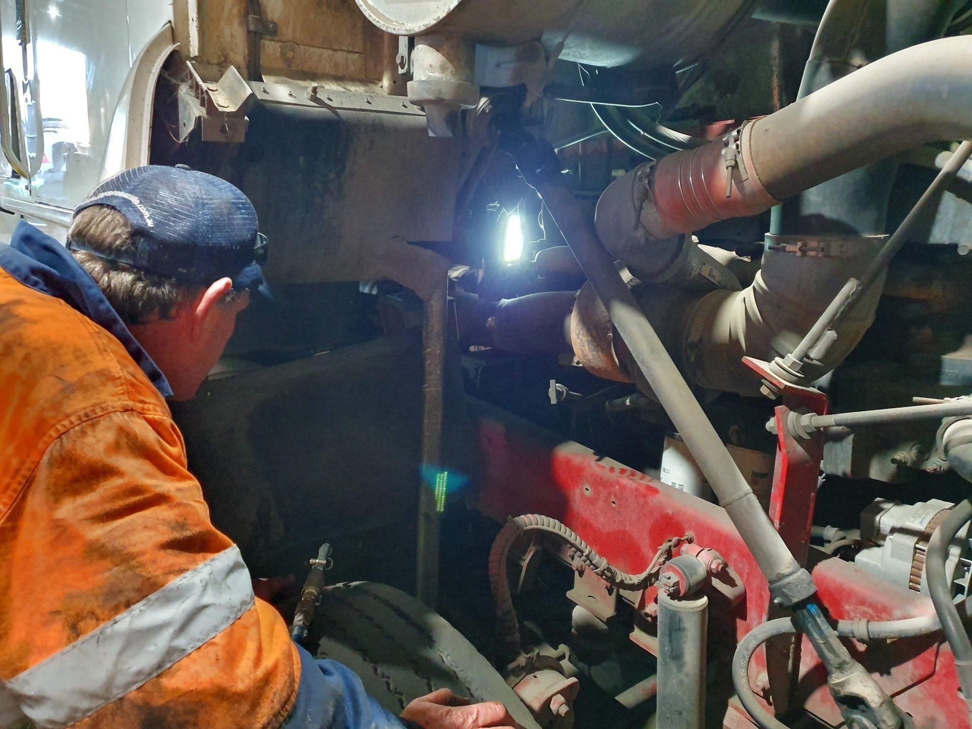 A Man Wearing A Welding Mask Is Working On A Vehicle — Newcastle Truck Repairs in Beresfield, NSW