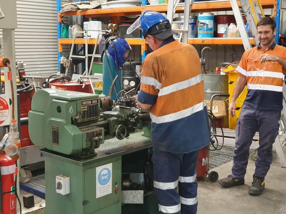 A Man Is Working On The Engine Of A Truck  — Newcastle Truck Repairs in Thornton, NSW