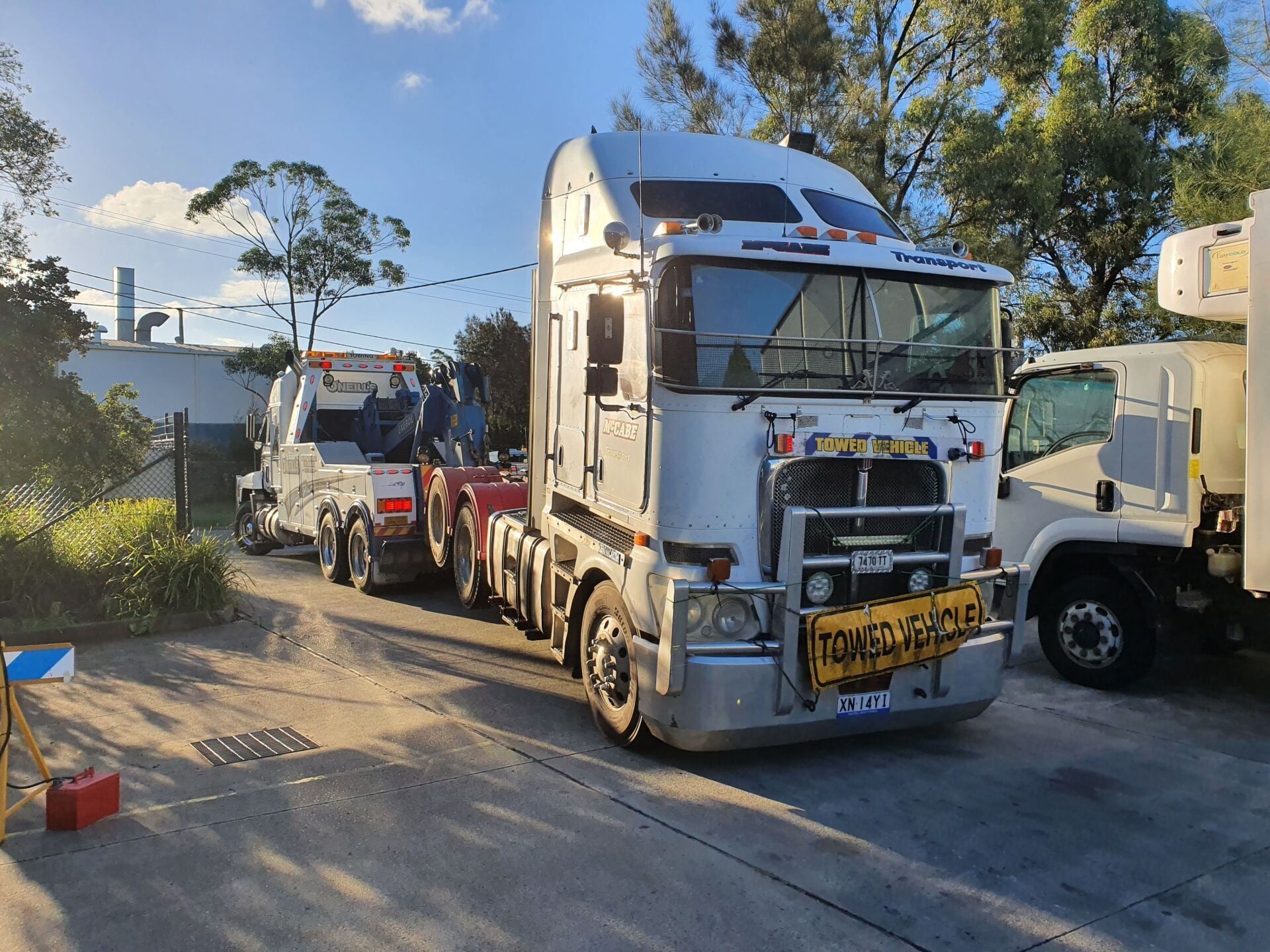 A Man Is Working On A Truck Engine With A Wrench  — Newcastle Truck Repairs in Thornton, NSW