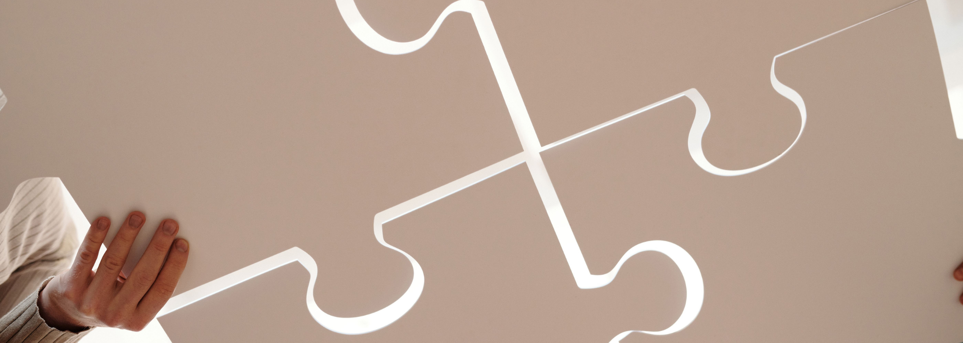 Picture of puzzle pieces coming together. 