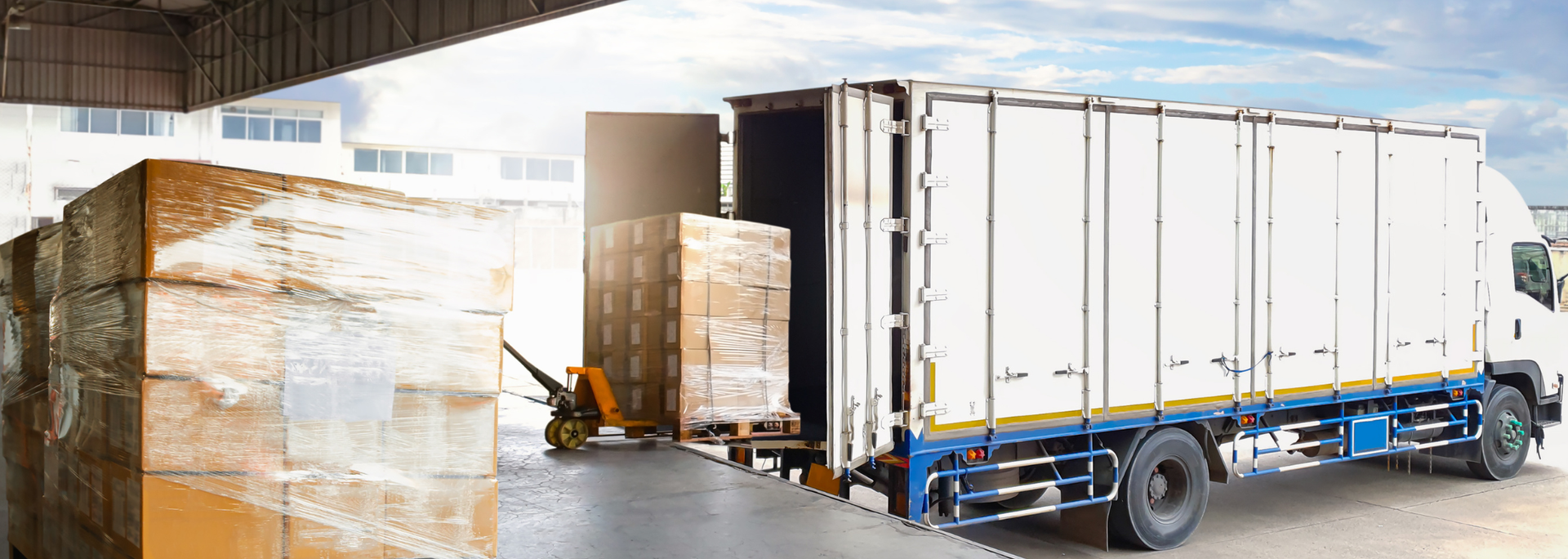Picture of a lorry unloading goods at a warehouse. Picture of a lorry unloading goods at a warehouse.