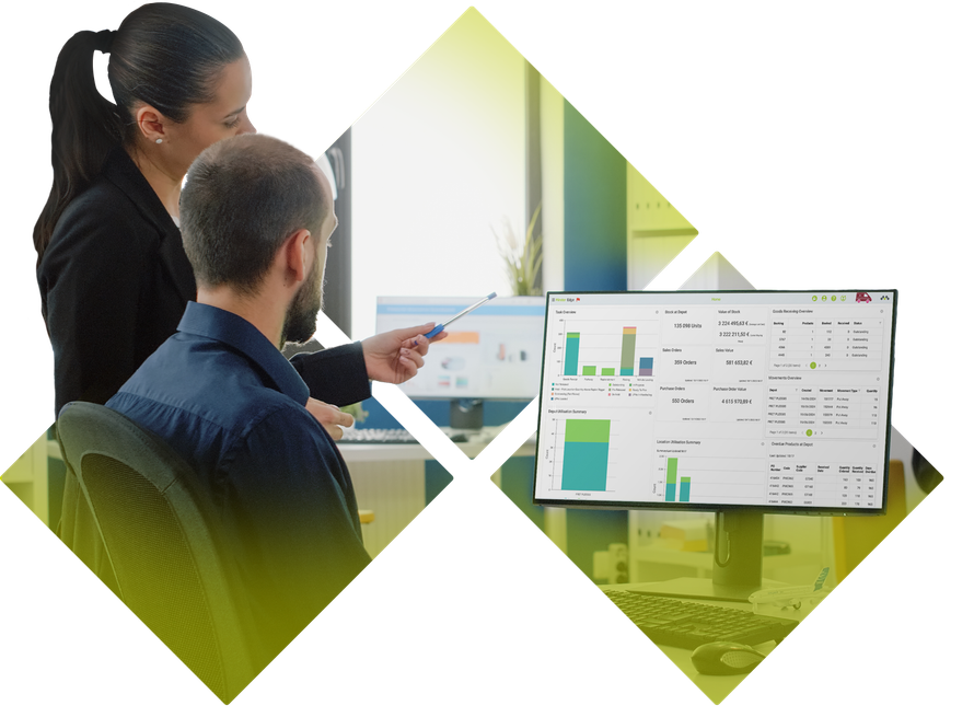 Two coworkers reviewing dashboard charts on a monitor in a bright office.