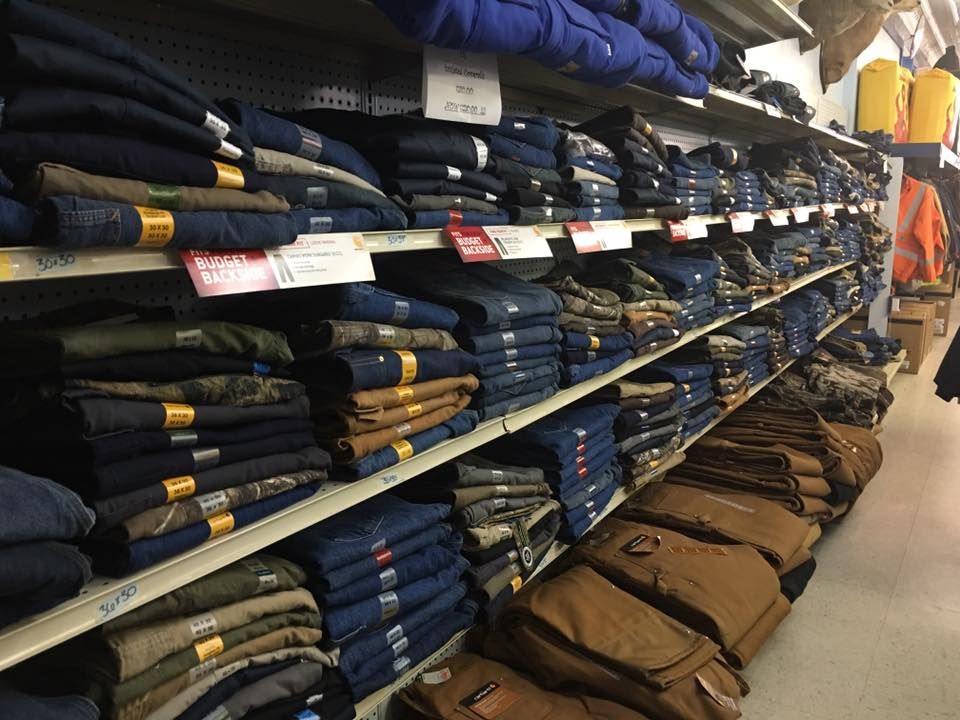 A store aisle filled with lots of clothes