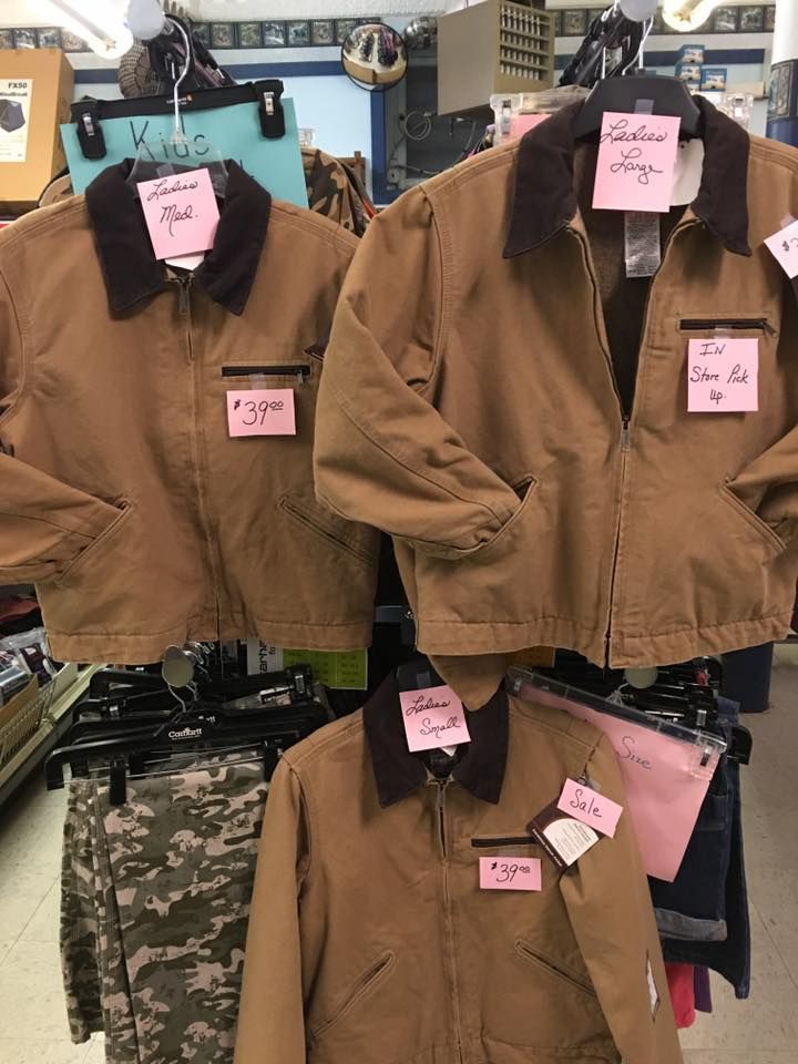 A bunch of jackets are hanging on a rack in a store