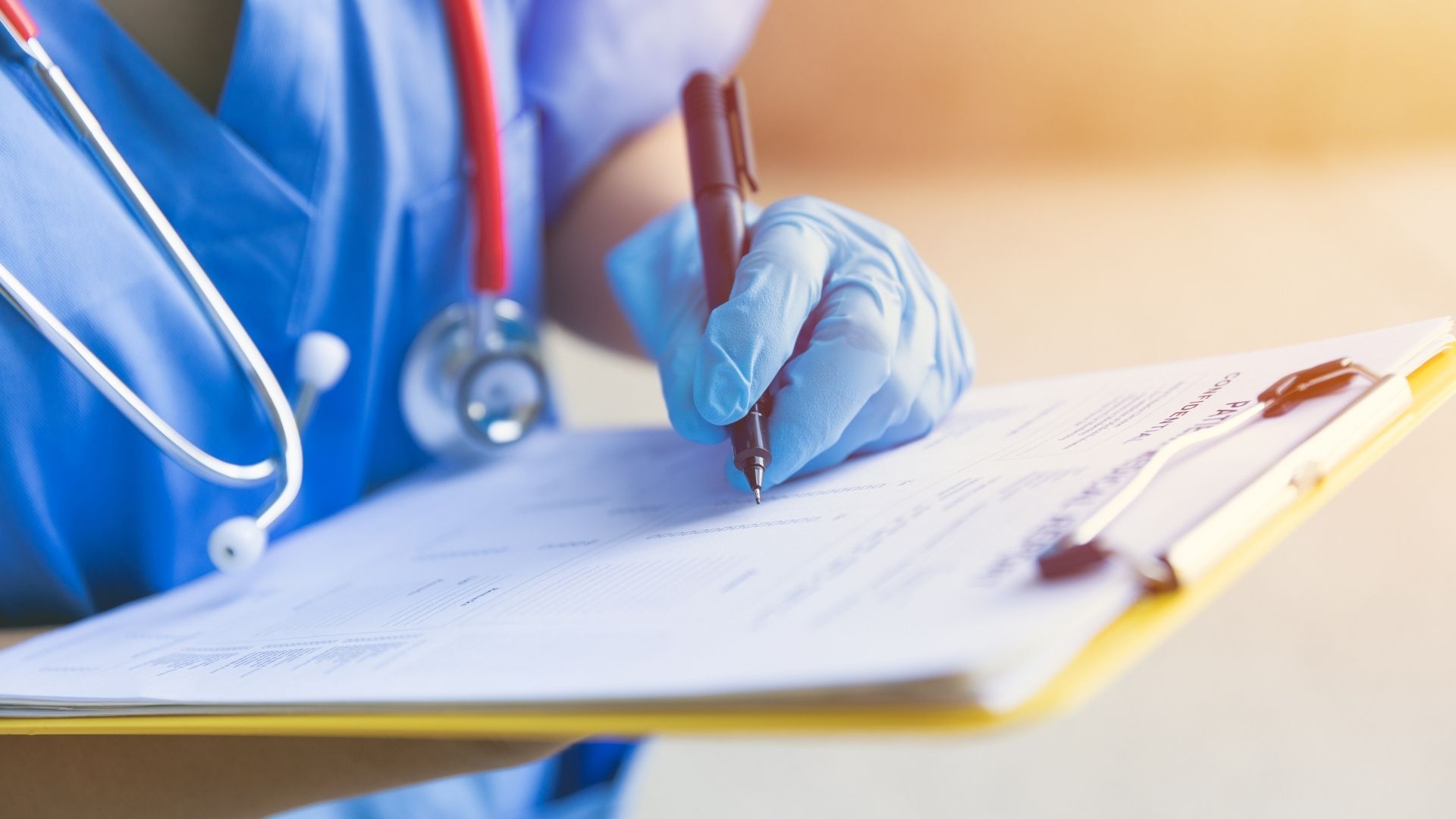 Doctor in white coat using a digital interface above a keyboard in a clinic setting