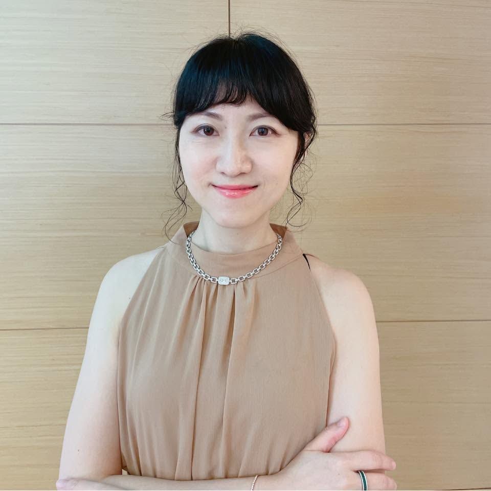 一張穿著西裝和黑色襯衫的男人的黑白照片。