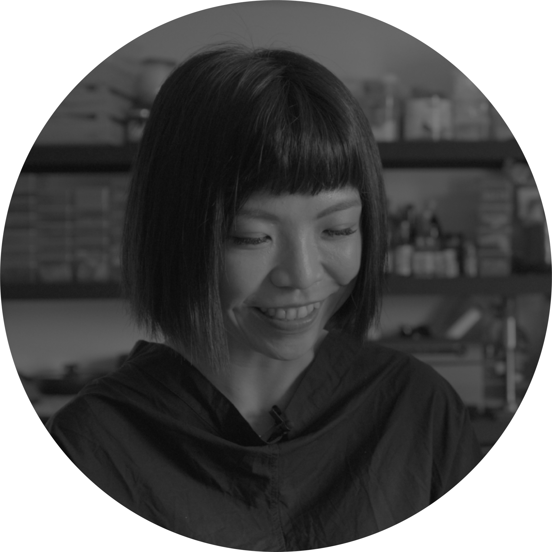 黑白照片中，一位短髮女子微笑著
