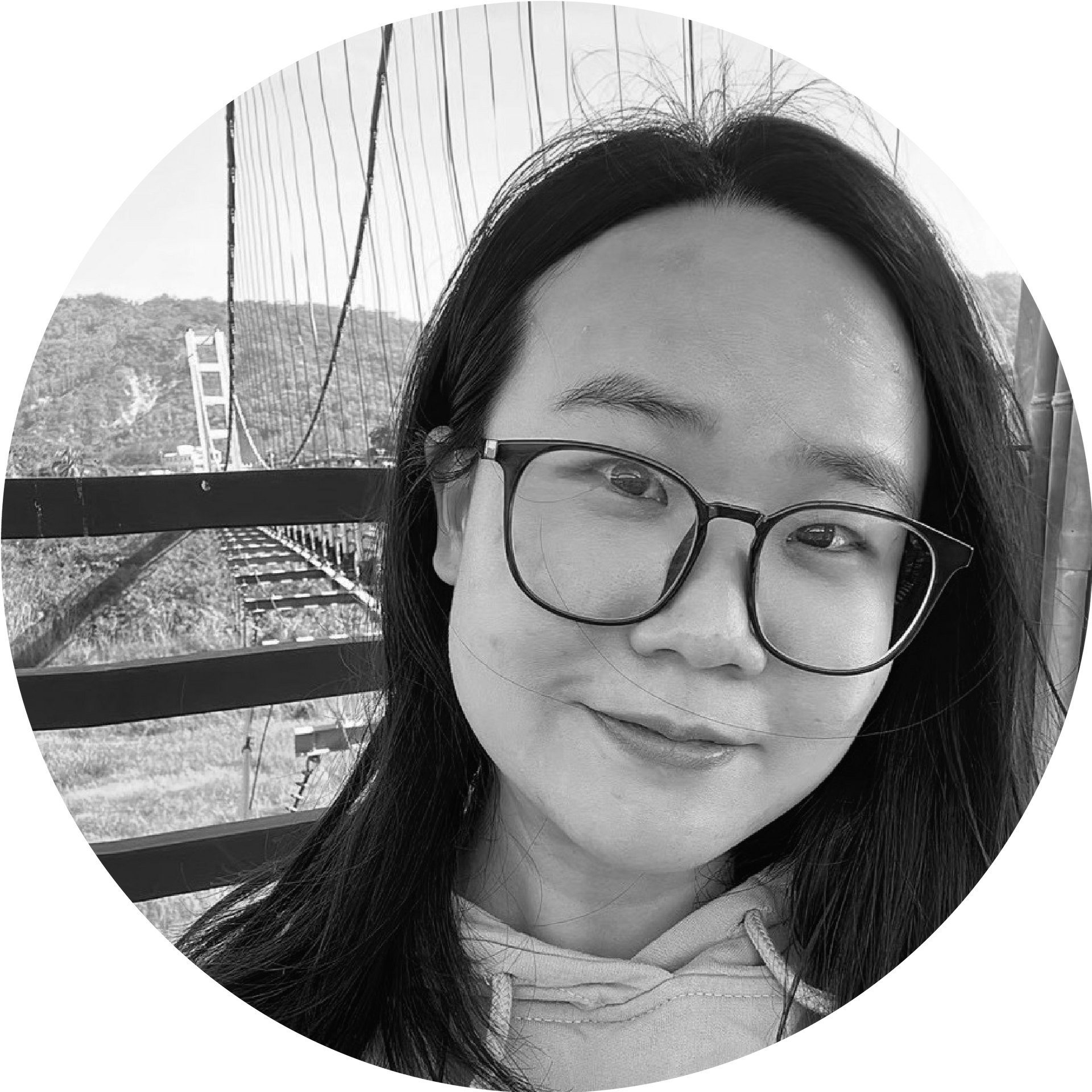 一張黑白照片中，一位穿著西裝和白襯衫的女人微笑著。