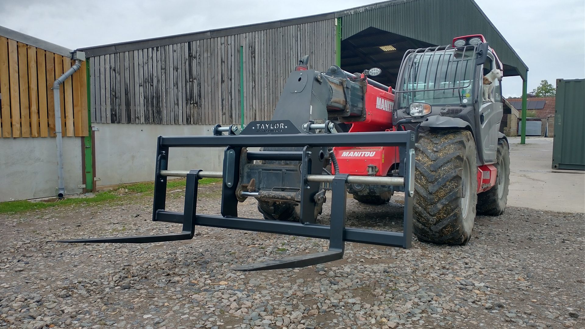 SHIPPING CONTAINER PALLET FORKS ON MANITOU TELEHANDLER