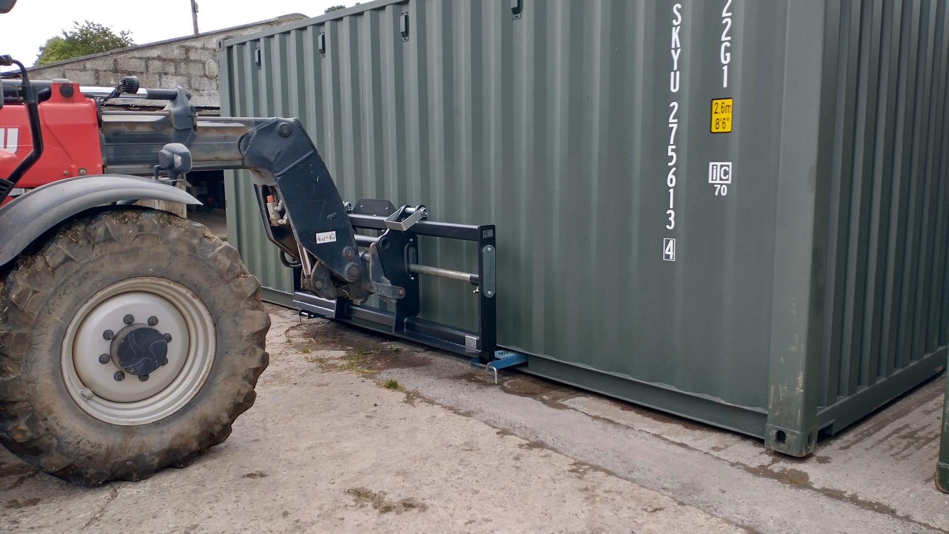 shipping container pallet forks on manitou telehandler