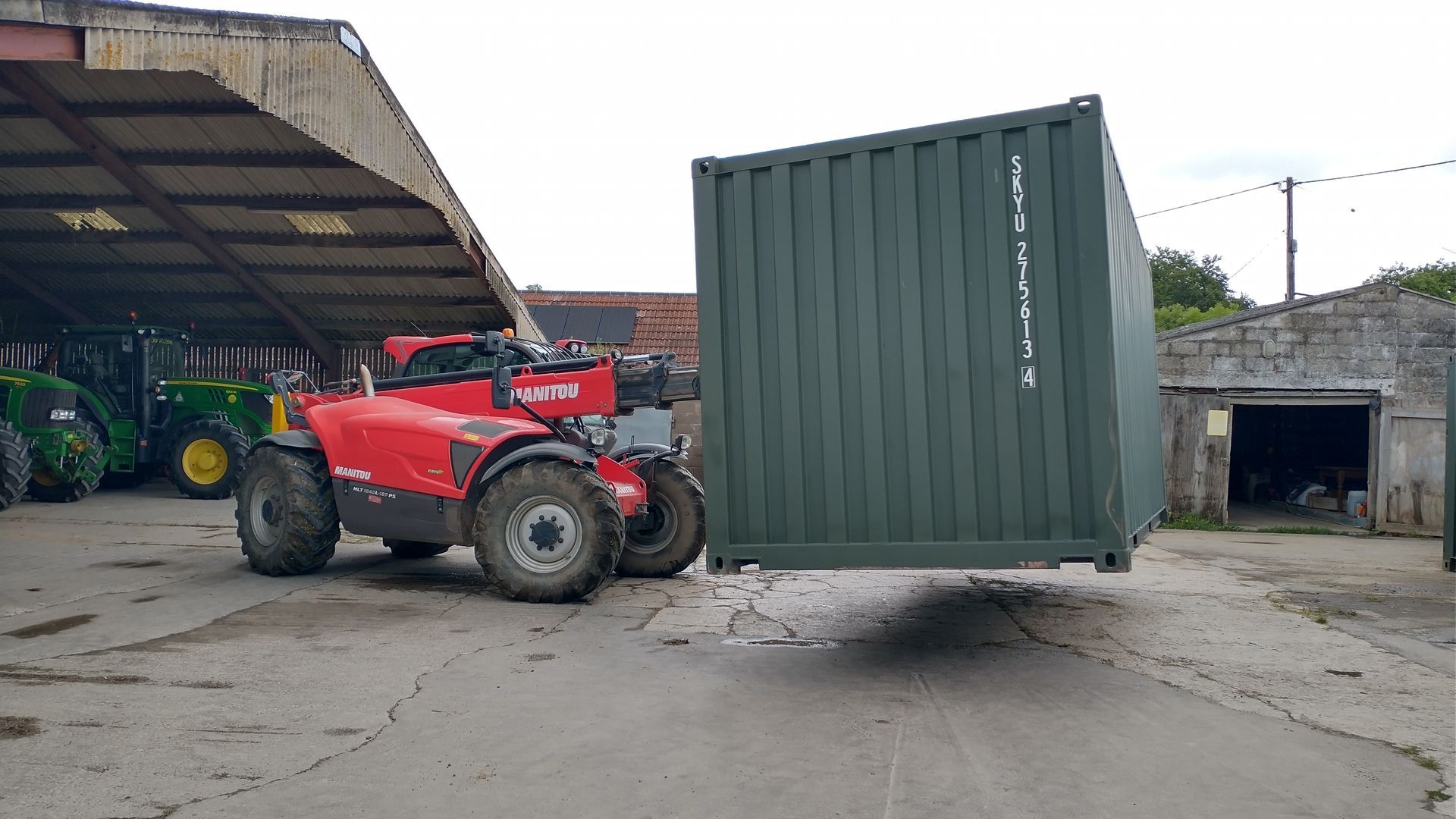 shipping container pallet forks on manitou telehandler