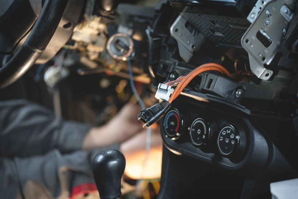 Auto Electrician Worker Is Installing A Car Alarm — A-Lect Auto Electrical & Air Conditioning In Garbutt QLD
