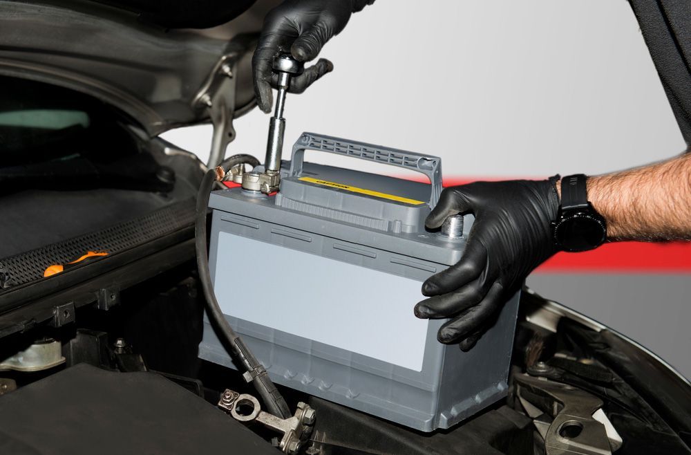 Technician Putting A New Battery Into A Diesel Car — A-Lect Auto Electrical & Air Conditioning In Garbutt QLD