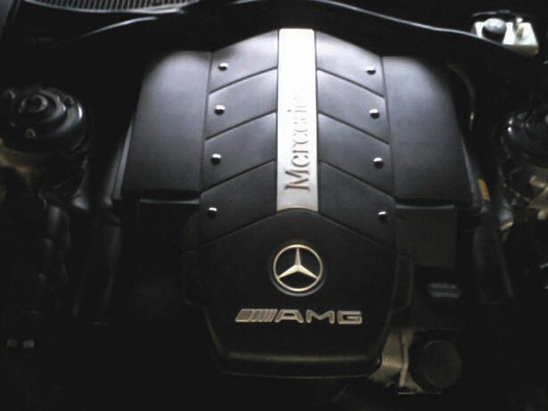 Mercedes-AMG engine cover with black and silver detailing and logo