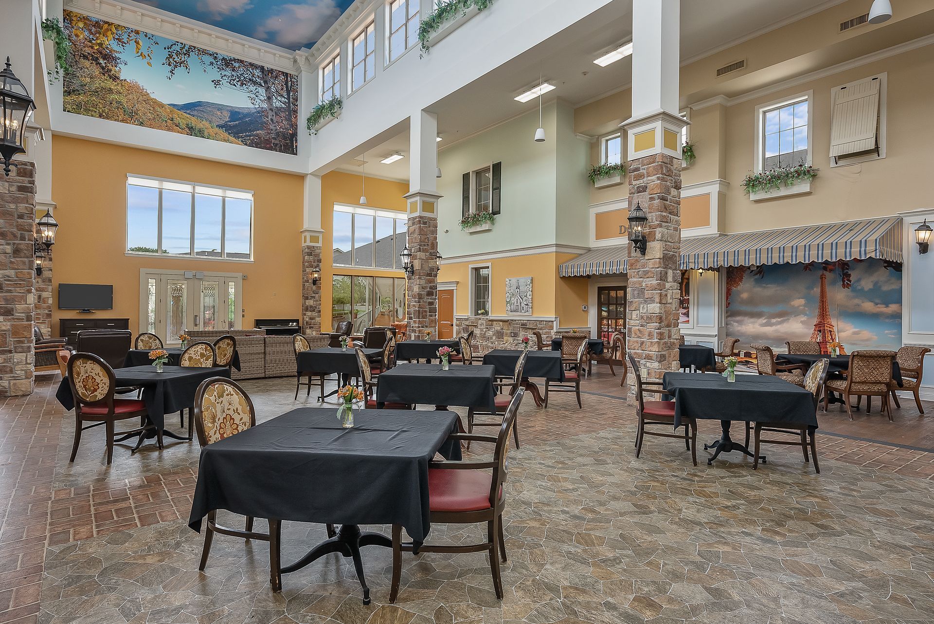 A large dining room with tables and chairs in a hotel.