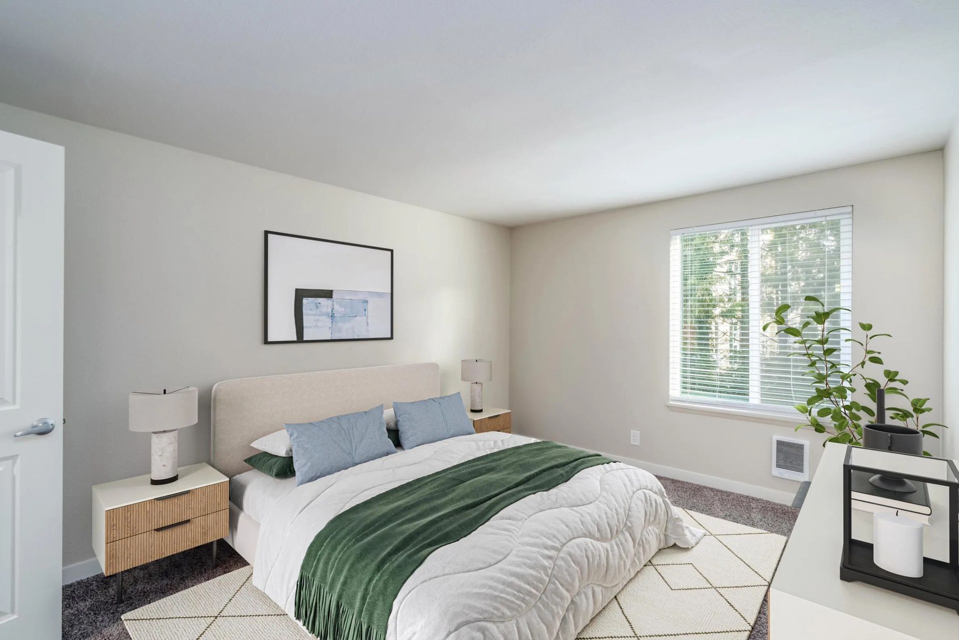 A modern bedroom with a bed featuring a green runner, a light wood nightstand, a framed print, and a window with blinds.