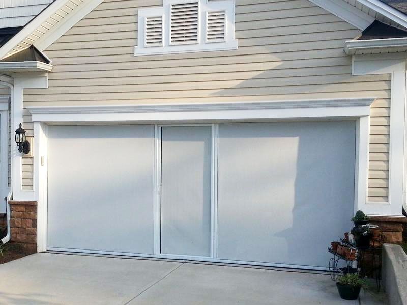 White double garage door on a beige house exterior
